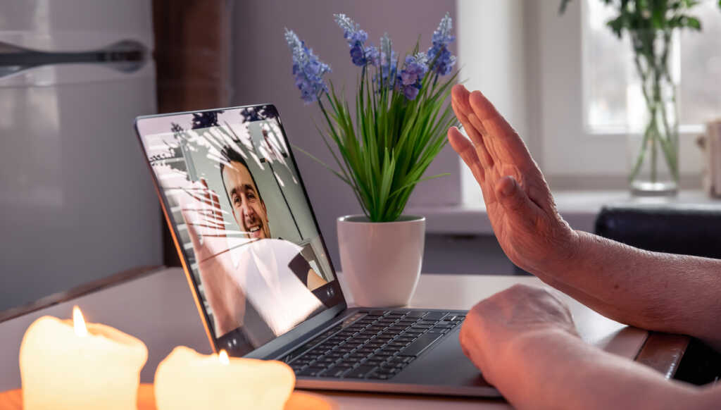 old-woman-communicates-with-her-son-via-video-link-through-laptop-scaled