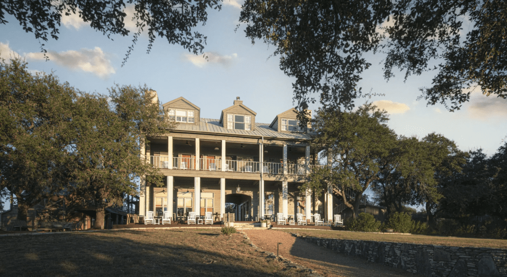 Sagehill mansion shot from outside with an old victory house with trees surrounding it.