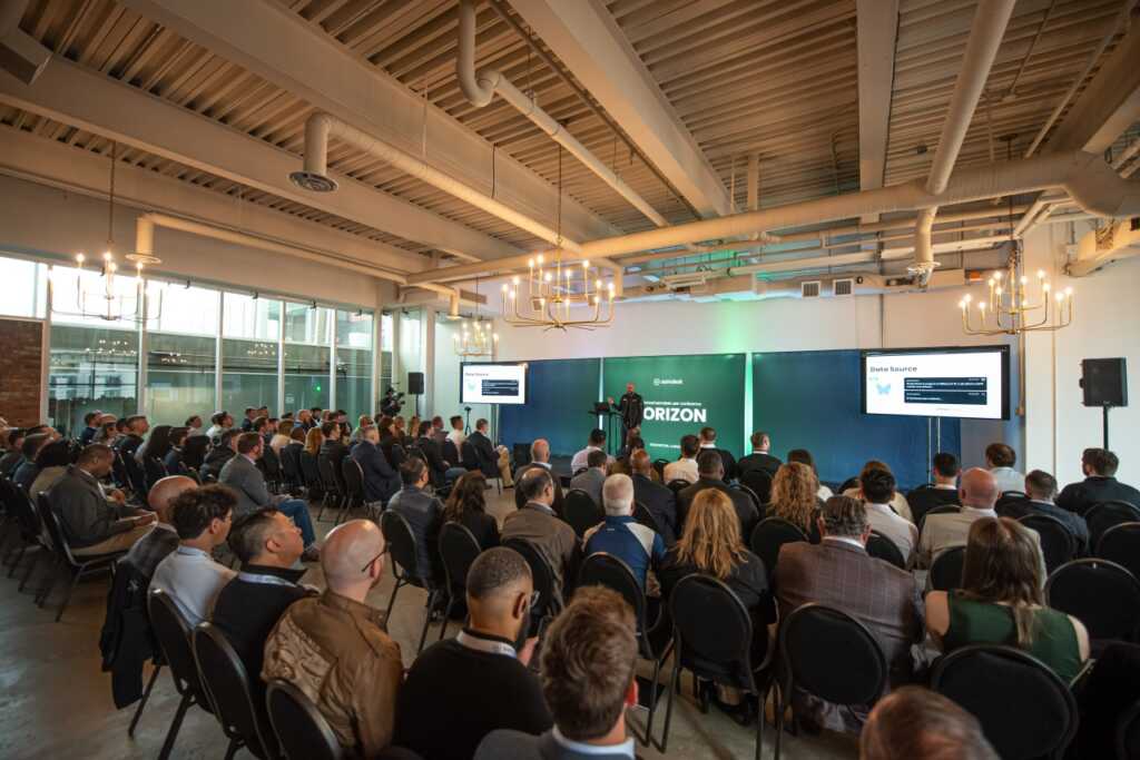 Samdesk retreat with the whole team listing to a speaker